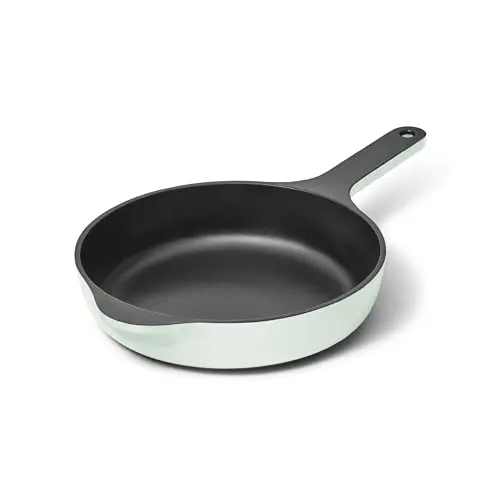 A light blue enameled cast iron skillet from Caraway with a stainless steel handle.